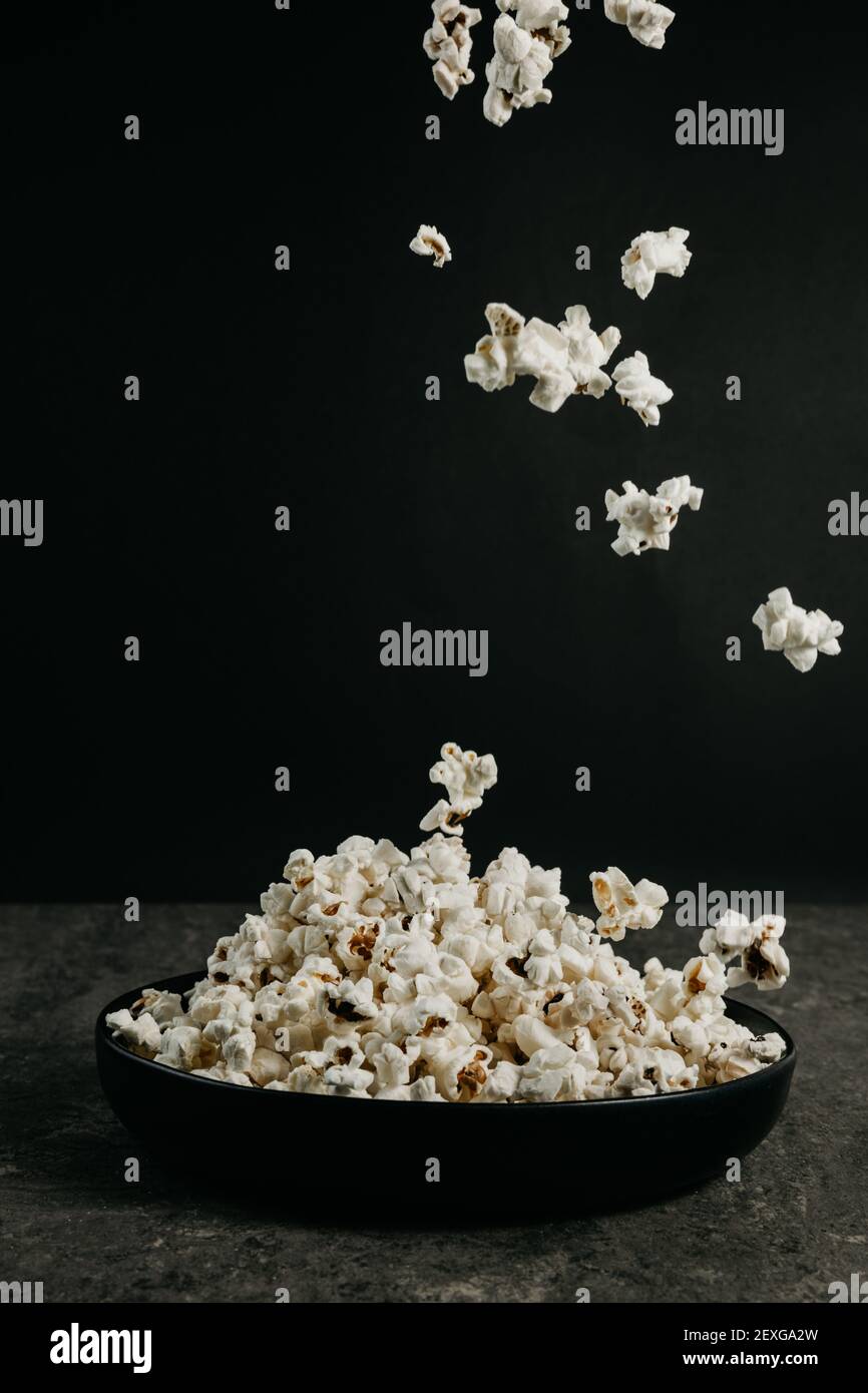 falling pop corn on black background Stock Photo