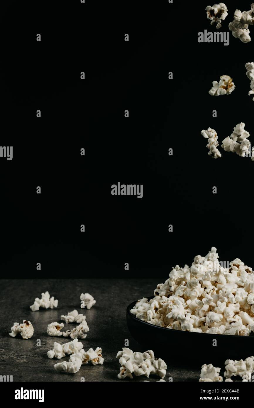 falling pop corn on black background Stock Photo