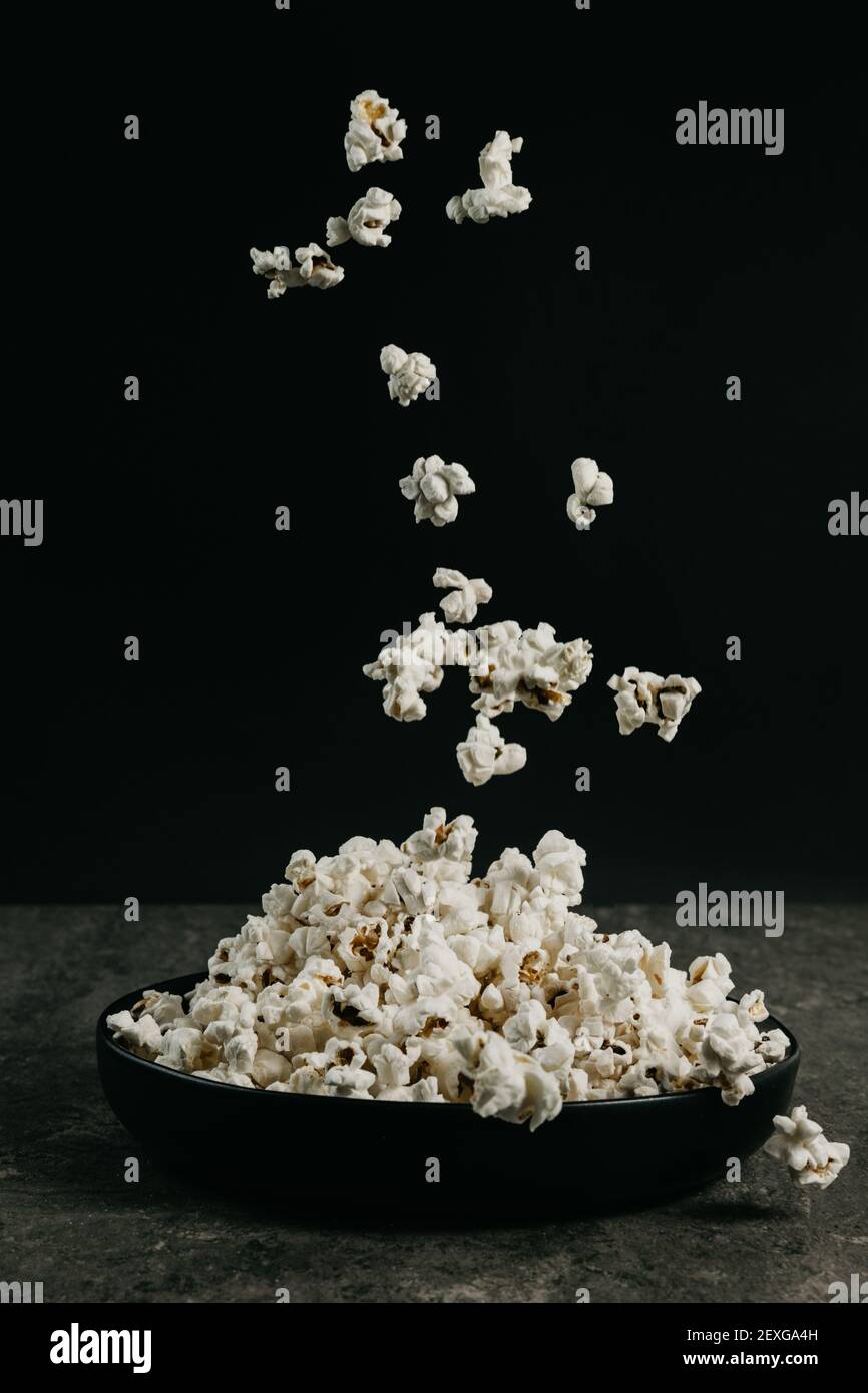 falling pop corn on black background Stock Photo