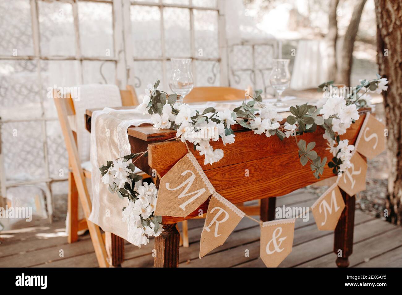 Vintage rustic outdoor wedding decoration - sweethearts table with white  florals, lace background, old window frame Stock Photo - Alamy, image size:1300x956