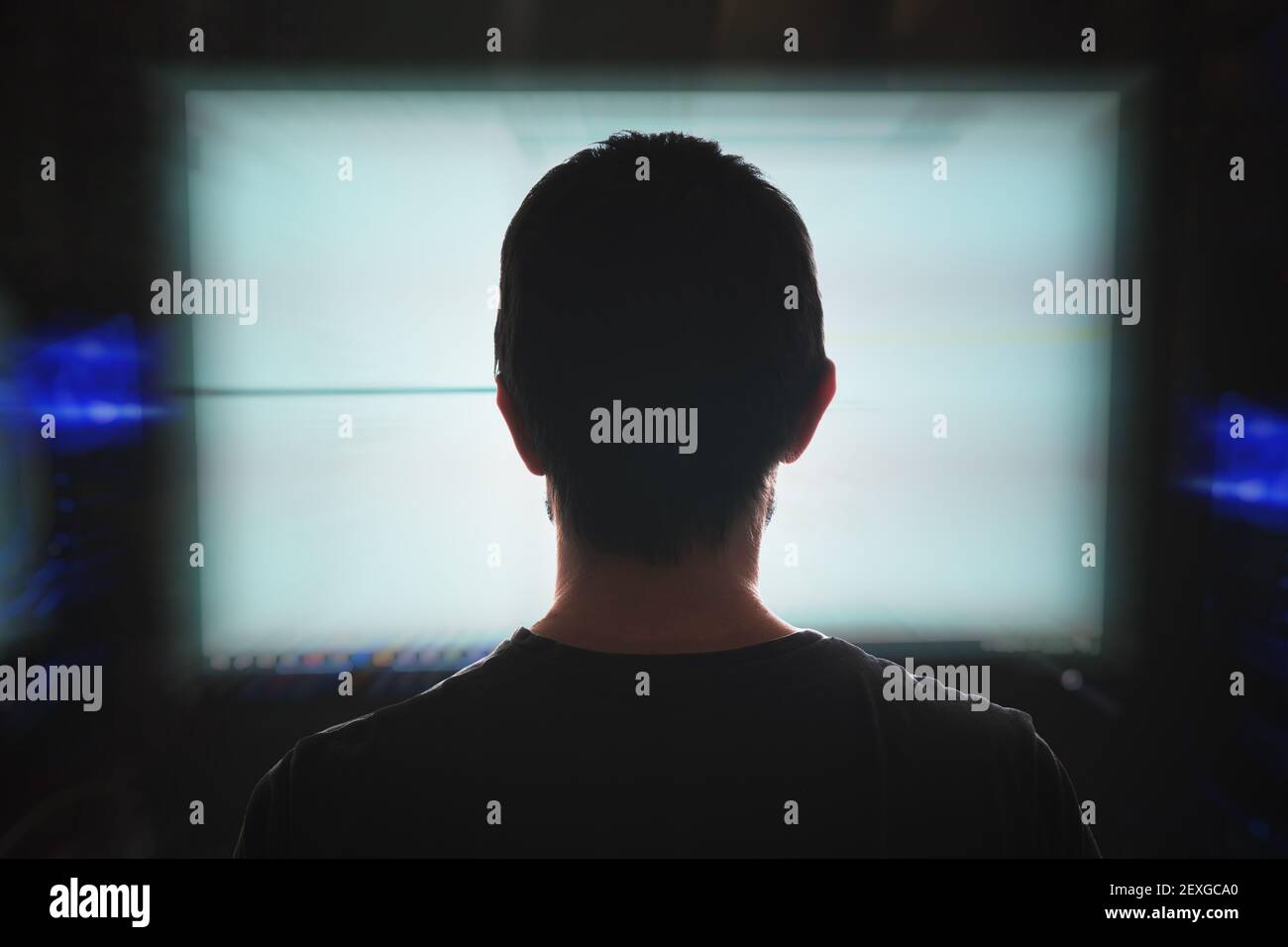 Young hacker programming behind computer hi-res stock photography and ...