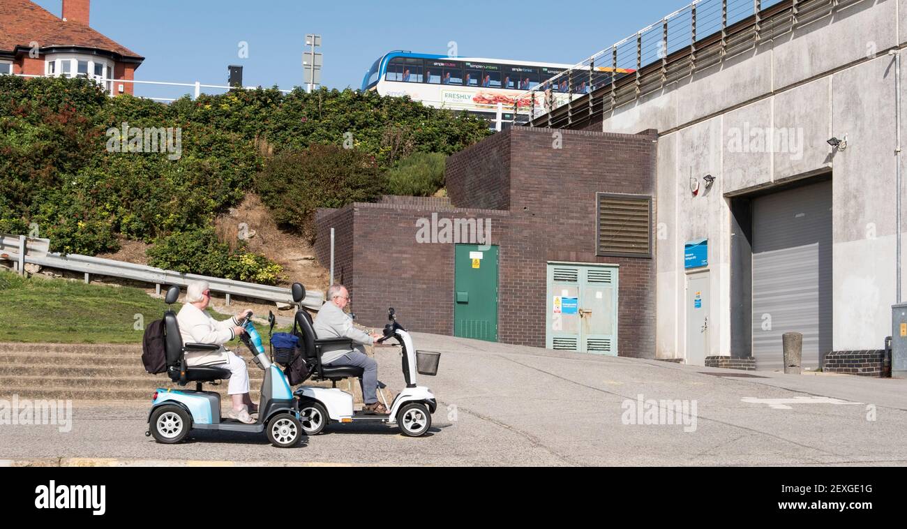 Two elderly people on mobility scooters Stock Photo Alamy