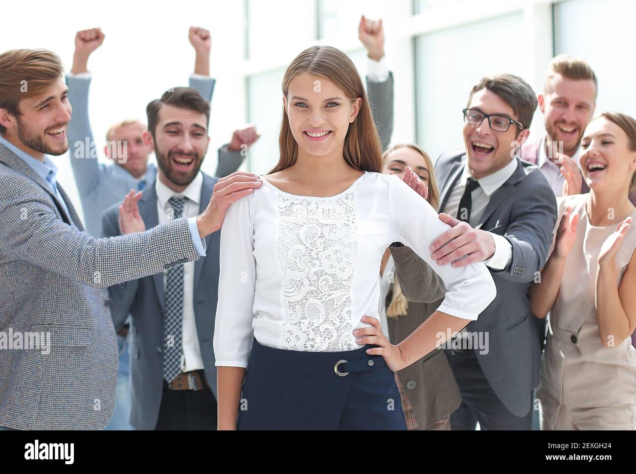creative business team congratulating their young colleague Stock Photo ...