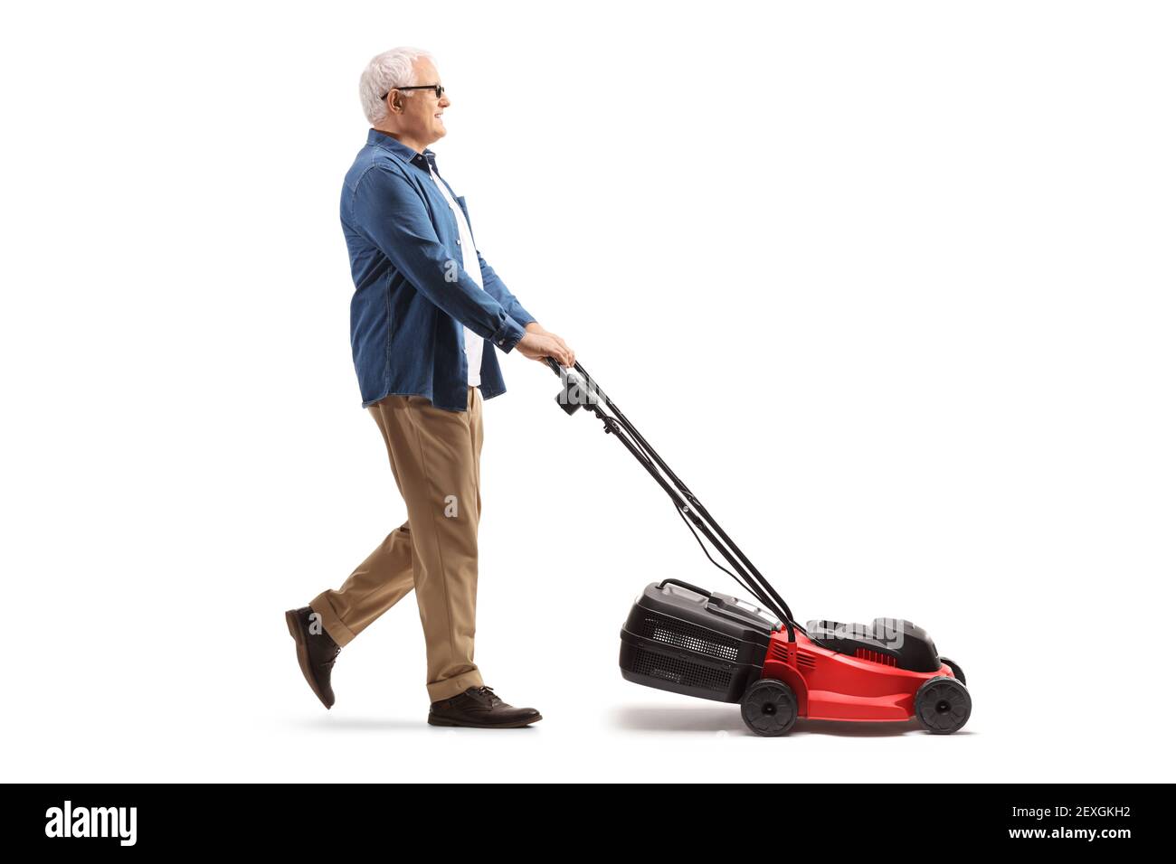 Full length profile shot of a mature man mawing with a lawnmower machine isolated on white background Stock Photo