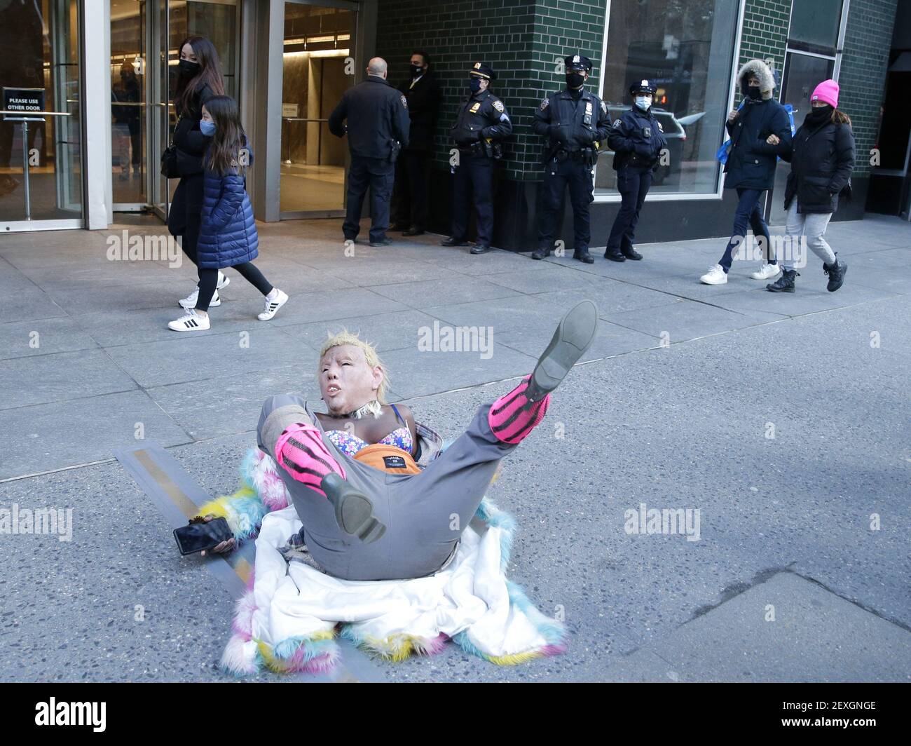 New York, United States. 04th Mar, 2021. A protester with a Donald Trump Mask lies on the sidewalk at an 'I Believe Women' protest outside of the Manhattan office of New York Gov. Andrew Cuomo in New York City on Thursday, March 4, 2021. Calls for New York Gov. Andrew Cuomo's resignation have increased after a third woman accused him of offensive behavior earlier this week. Photo by John Angelillo/UPI Credit: UPI/Alamy Live News Stock Photo