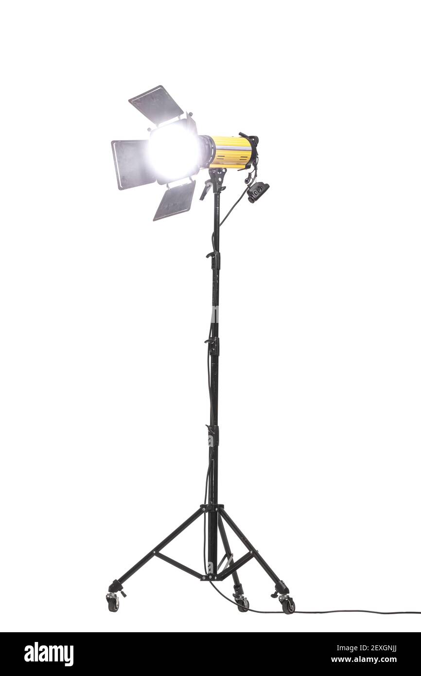 Flash light with barn doors on stand with wheels. Studio lighting equipment isolated on white background. Stock Photo