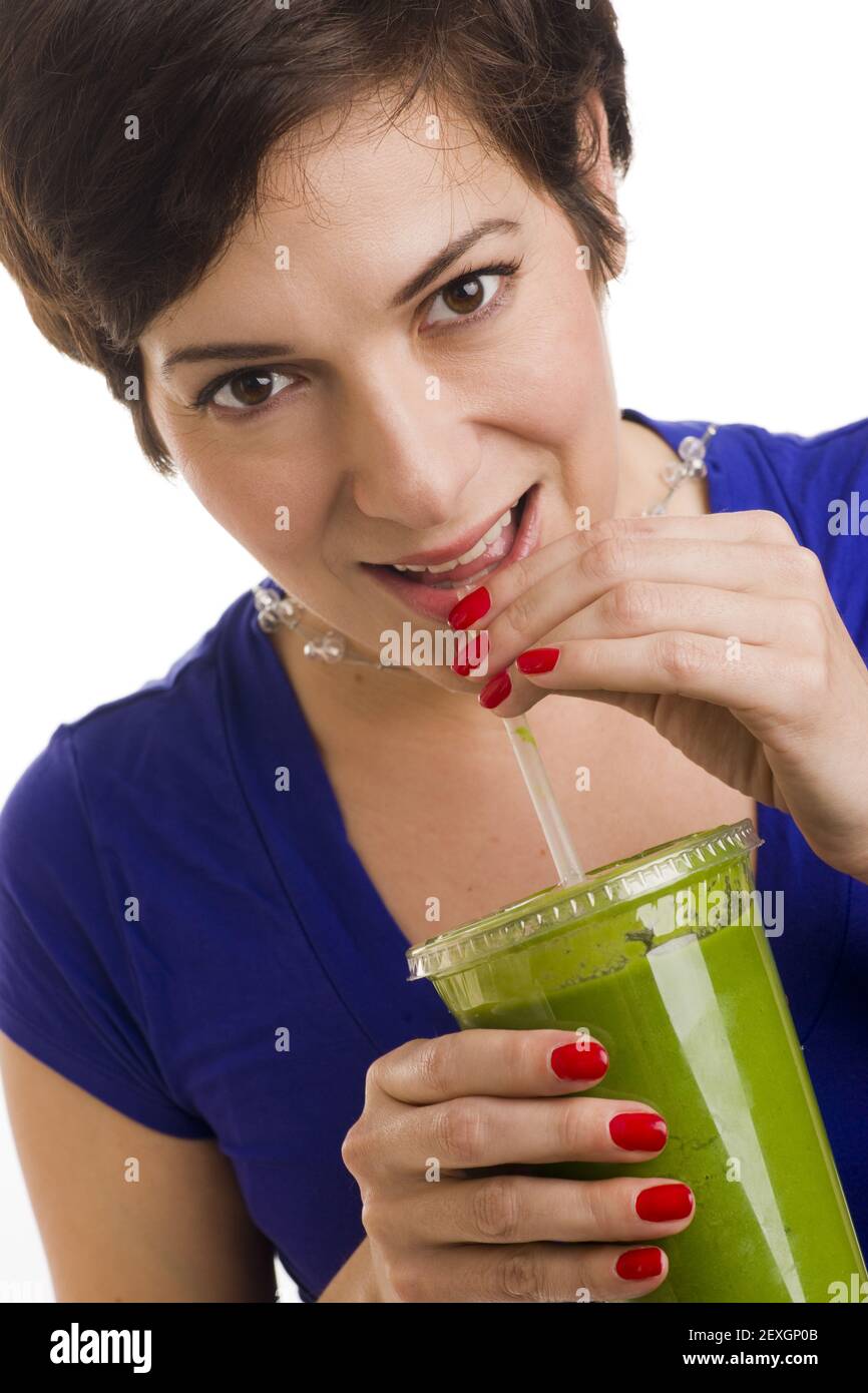 Woman sips Green Smoothie Stock Photo