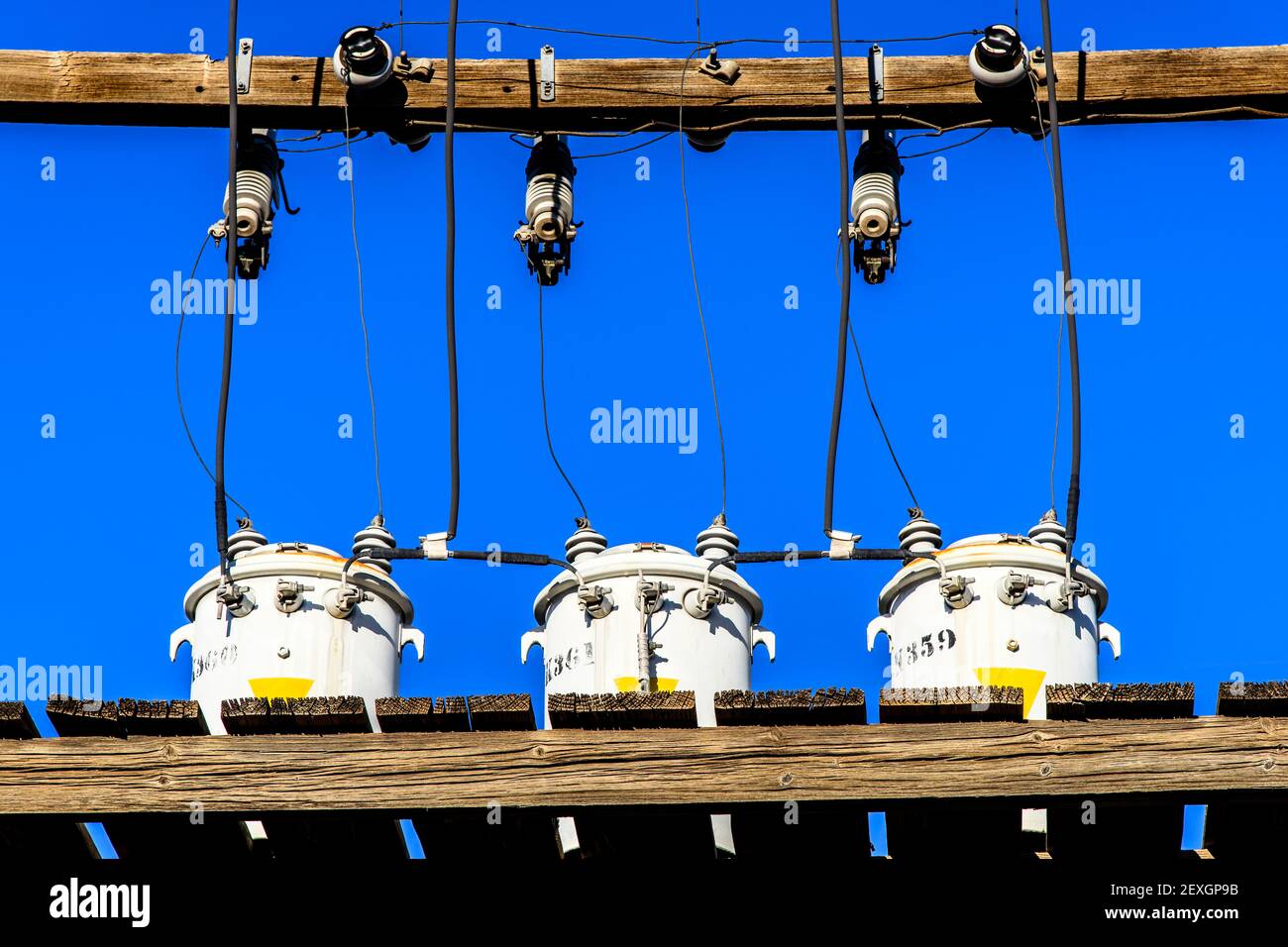 3 electric transformers on a pole platform in the Arts District of Las Vegas Stock Photo