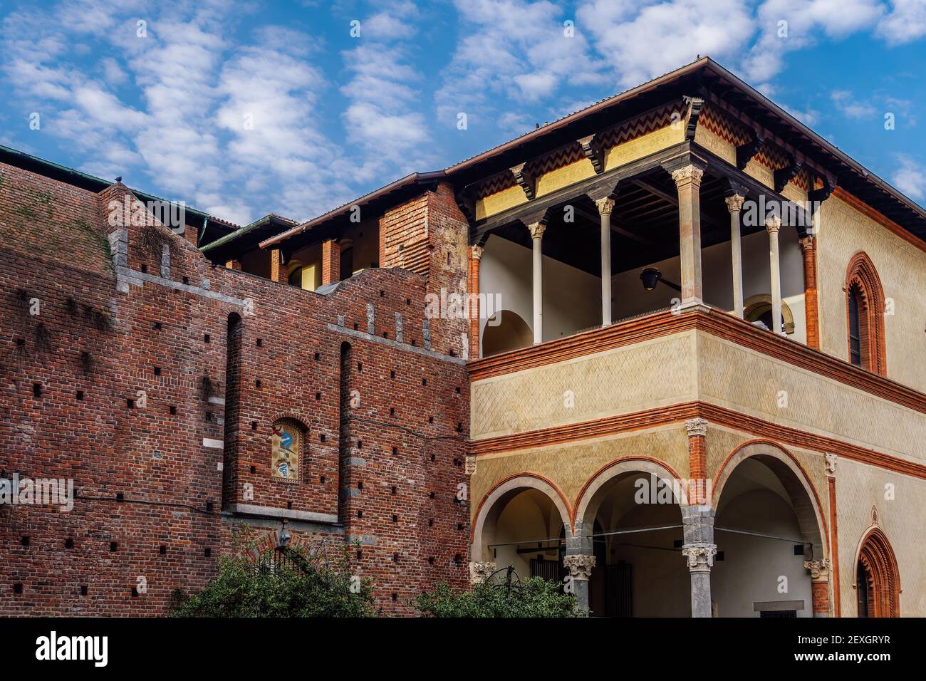 Milan, Italy Ducal Courtyard low angle day view of Sforzesco Castle - Castello Sforzesco - Medieval apartments residence, the loggia of Galeazzo Maria Sforza against puffy clouds sky. Stock Photo
