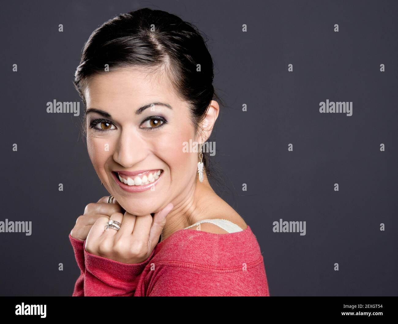 Pretty Woman in a red sweater looking at the camera Stock Photo