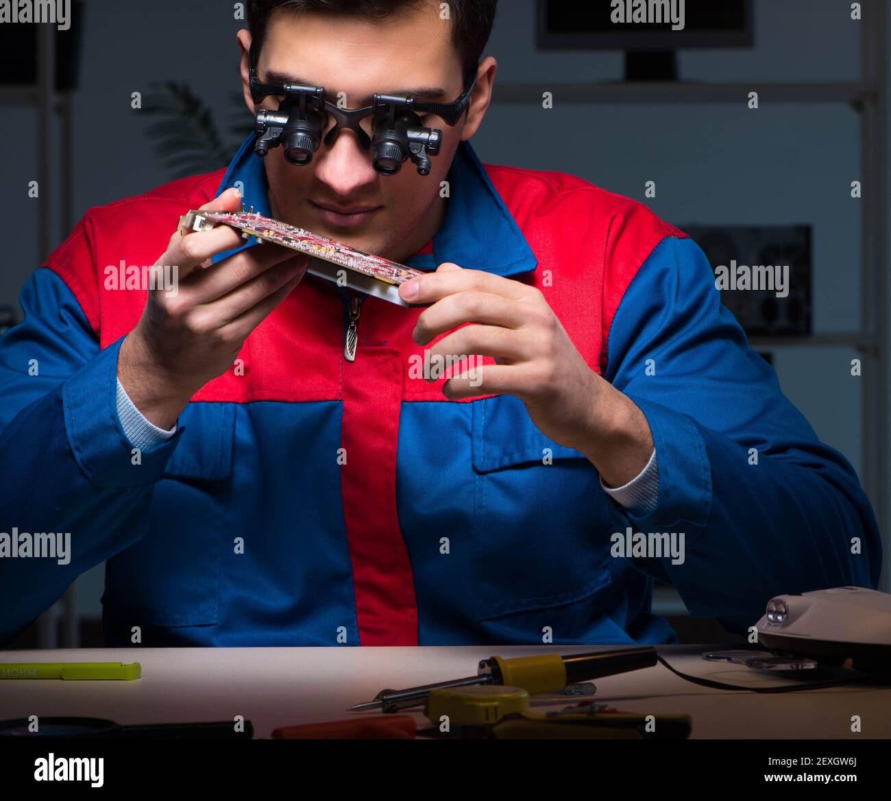 The computer specialist repairing pc late at night Stock Photo - Alamy