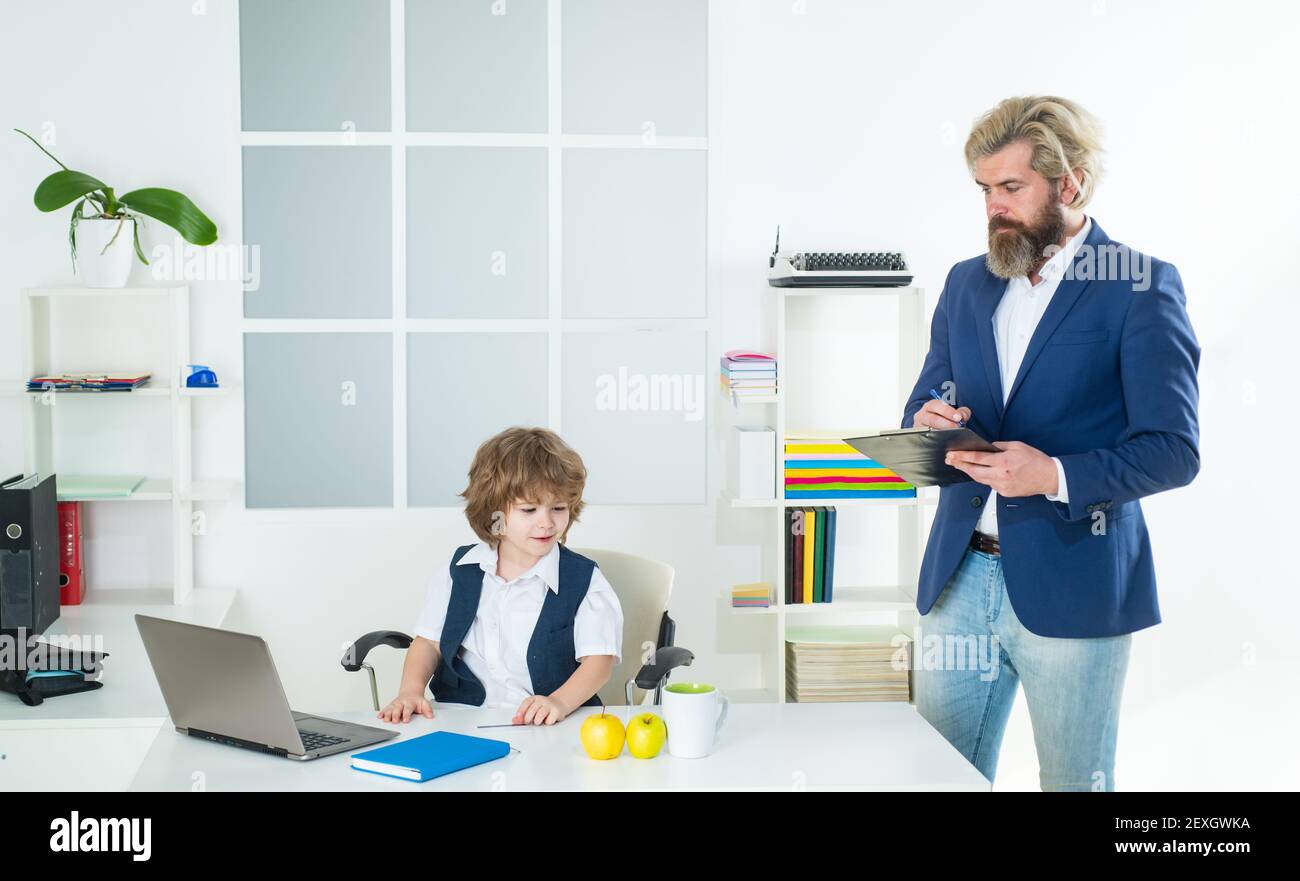 Marketing team meeting brainstorming research. Cute kid sitting in office chair self confident like big boss, funny businessman bossy child, director Stock Photo