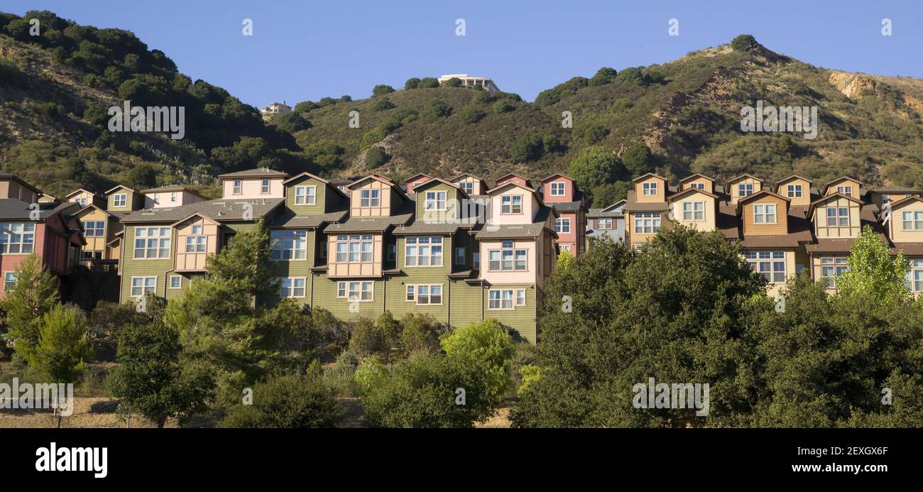 Urban Sprawl Dwellings Spring up For Domestic Living on Hillside Stock Photo