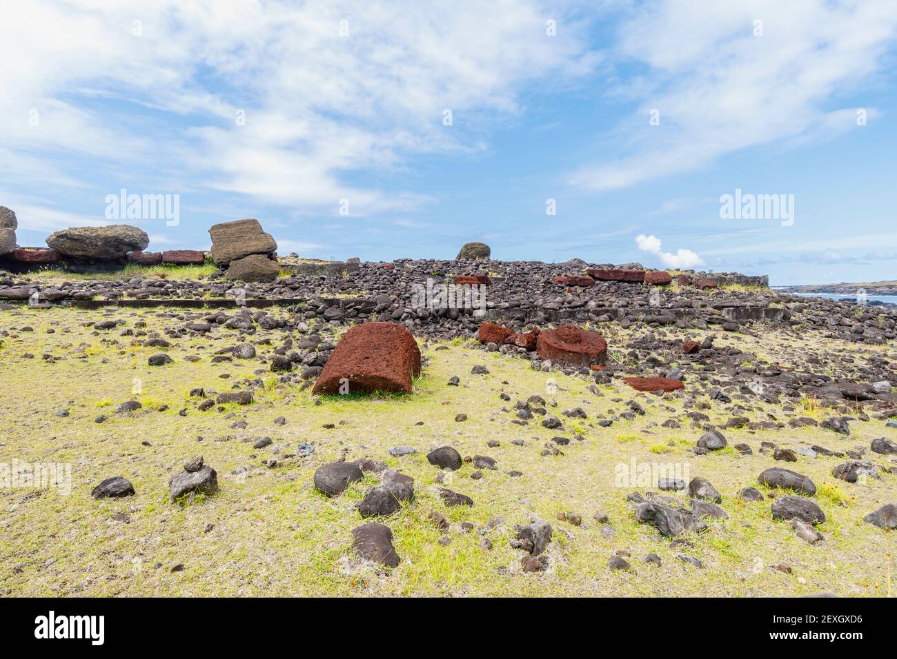 Fallen toppled moai (statues) and red pukao (topknots) at Ahu Akahanga