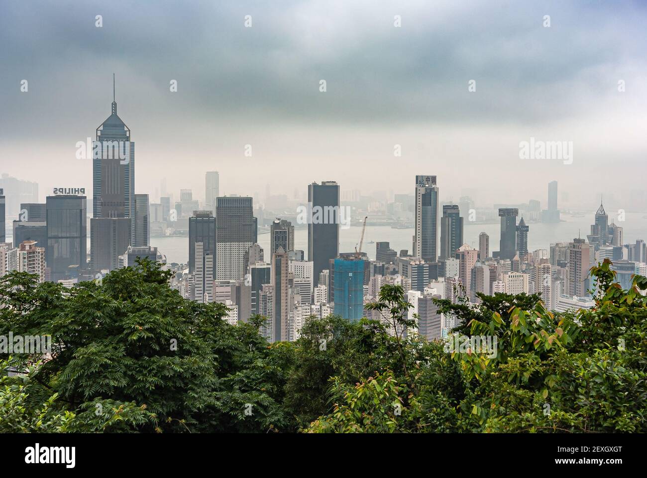 Hong Kong, China - May 12, 2010: Looking down from Victoria Peak on Hong Kong Island and Kowloon cityscape with skyscrapers and Victorial harbor. Fogg Stock Photo