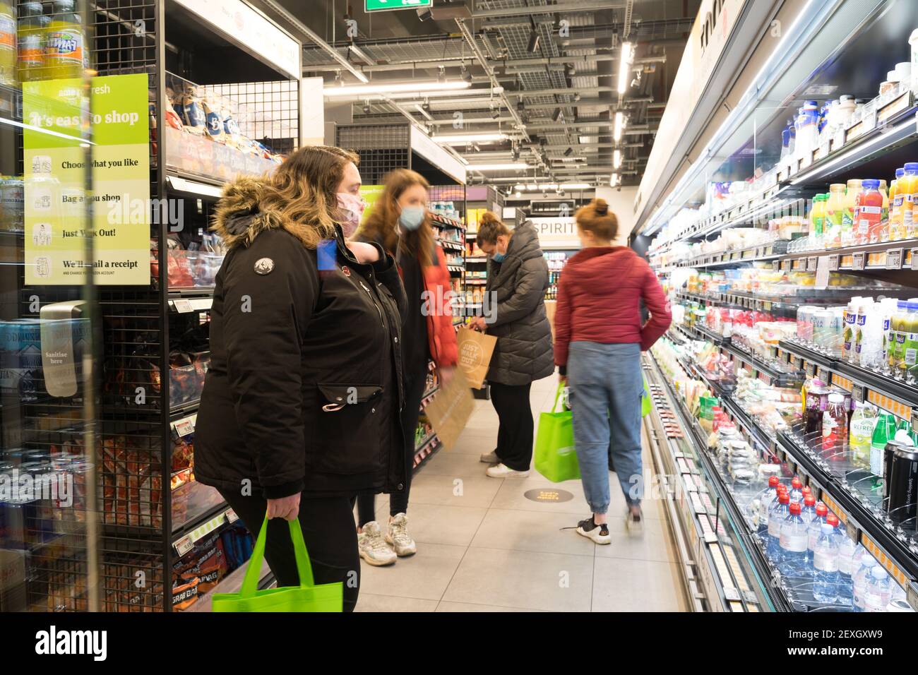women shoppers looking at soft drinks aisle at Amazon fresh , its first store with "Just walk out" at Ealing London, UK Stock Photo
