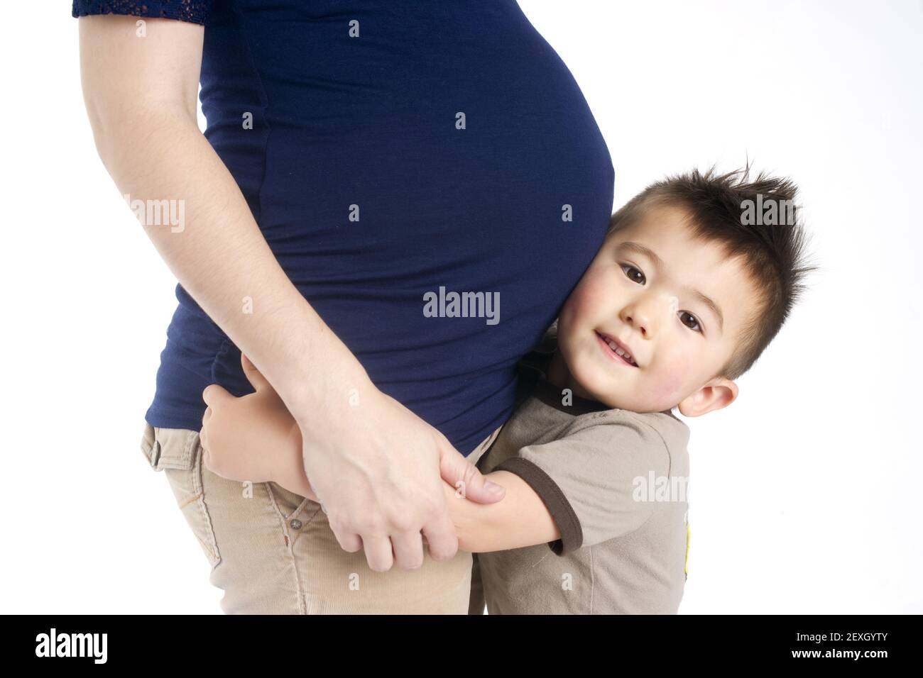 Firstborn Child Boy Hugs Mothers Pregant Belly Ready for Sister Stock Photo