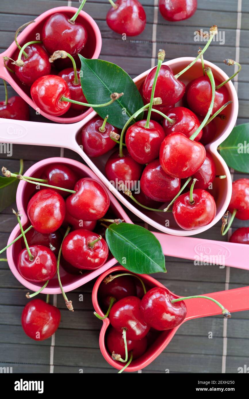 Fresh cherries in measuring cups Stock Photo Alamy