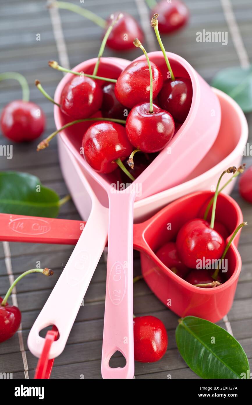 Fresh cherries in measuring cups Stock Photo Alamy