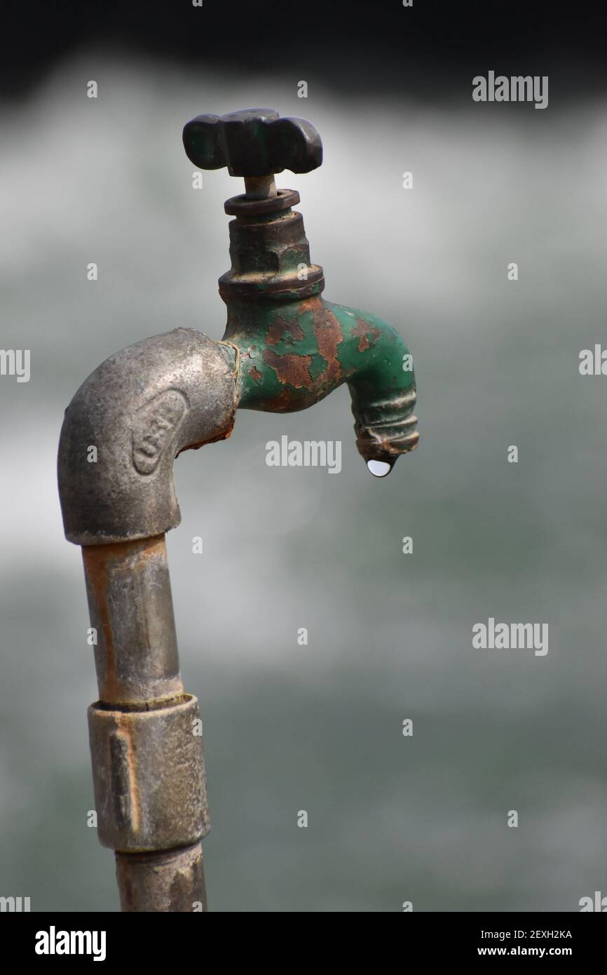 A vertical shot of a rusty garden tap with a water drop Stock Photo Alamy