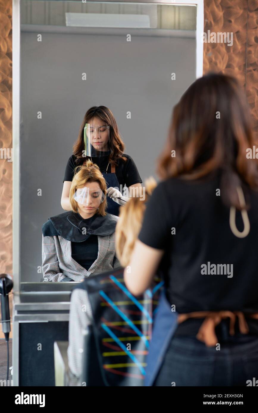 Hairdressers, working in salons with COVID19 safety measures, are