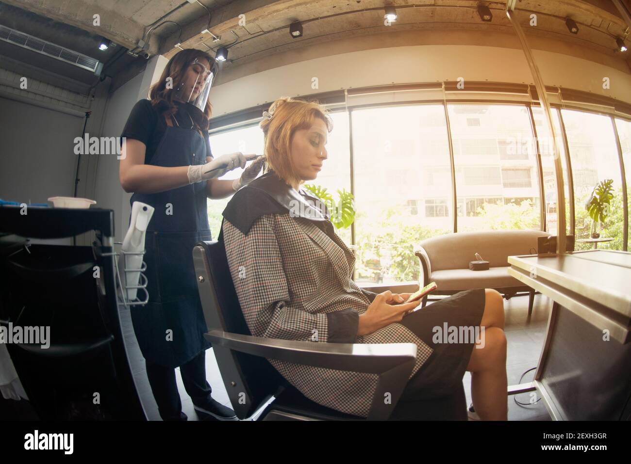 Hairdressers, working in salons with COVID19 safety measures, are