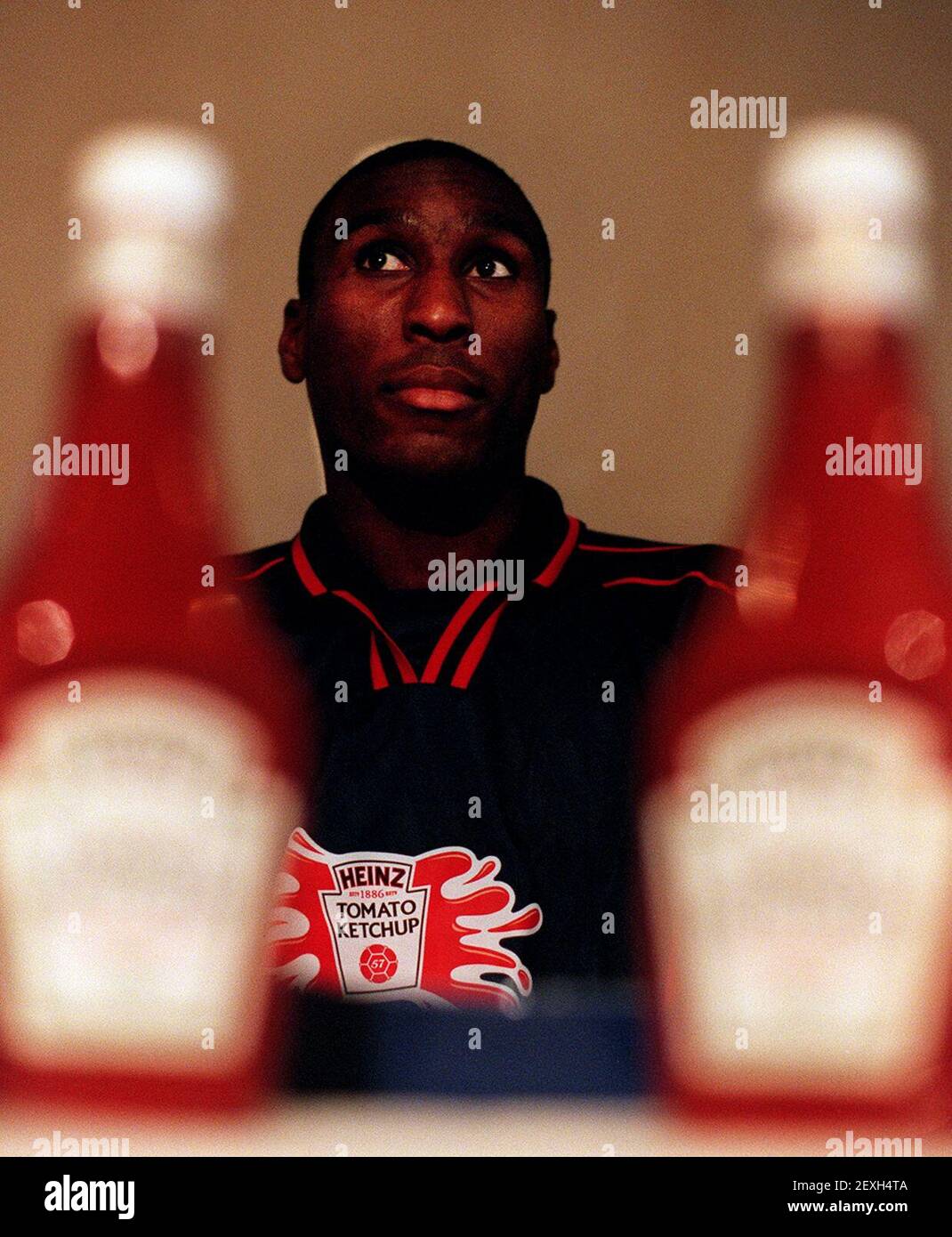 Sol Campbell Tottenham Hotspur Defender January 1999eats his way through the first edible football draw for the heinz ketchup cup, the largest schoolboy football tournament in the uk at the sports cafe in London Stock Photo