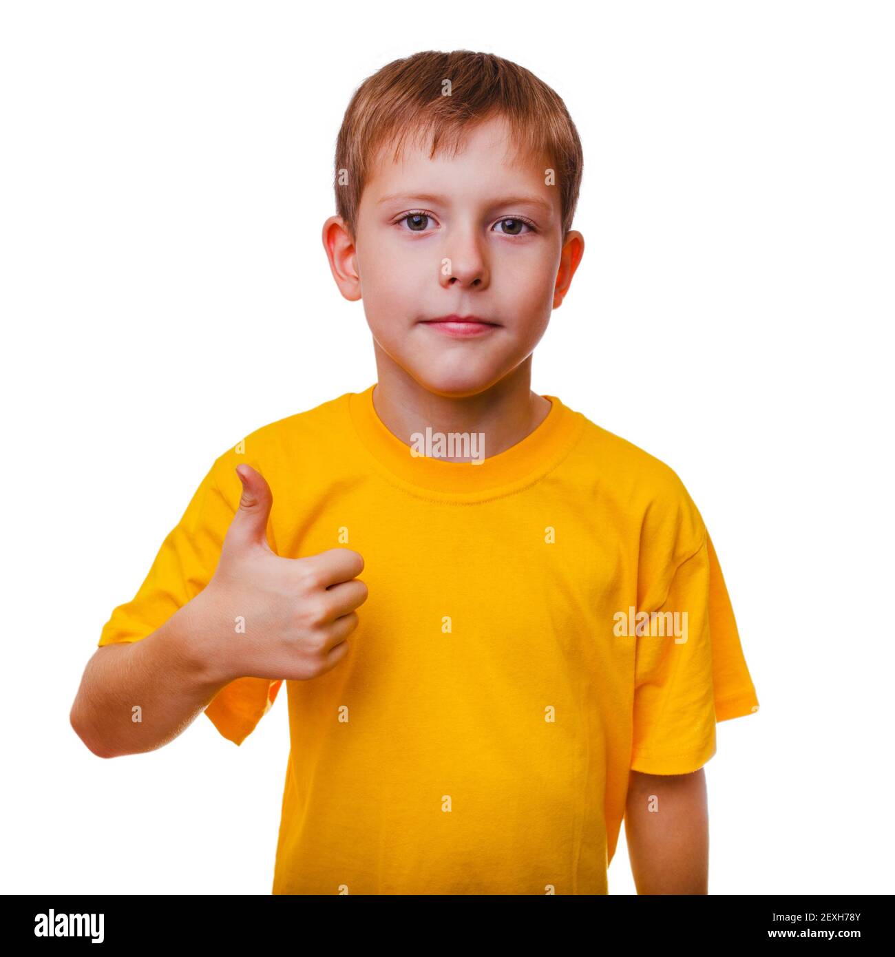 Blond boy kid in yellow shirt holding a thumbs-up, showing the Stock Photo