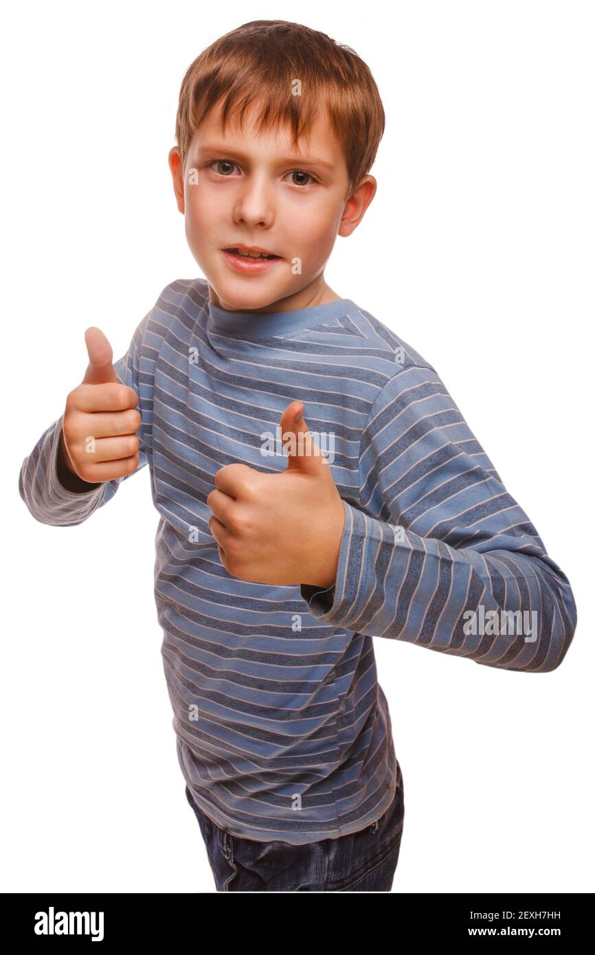 Boy kid blonde in striped jacket holding thumbs up, showing sign Stock Photo