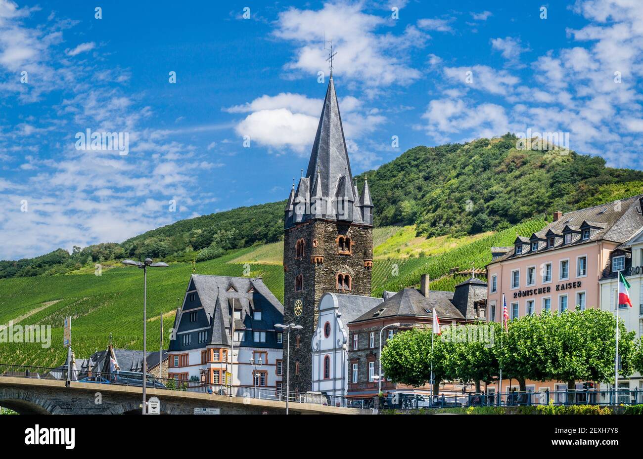 the bell tower of the Parish Church of St. Michael forms a distinctive part of the silhouette of Bernkastel-Kues, a wine growing town on the Middle Mo Stock Photo