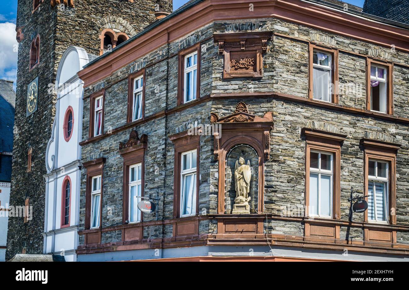 statue of Archangel Michael as a warrior saint slaying a dragon at a corner niche next to the Parish Church of St. Michael in Bernkastel, Bernkastel-K Stock Photo