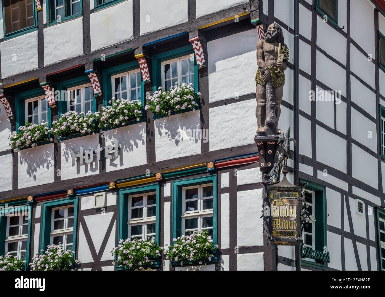 wood sculpture of a sage man at the medieval half-timbered edifece of Hotel Restaurant 'Zum Wilden Mann', Marktplatz Soest, Soest, Westphalia, North R Stock Photo