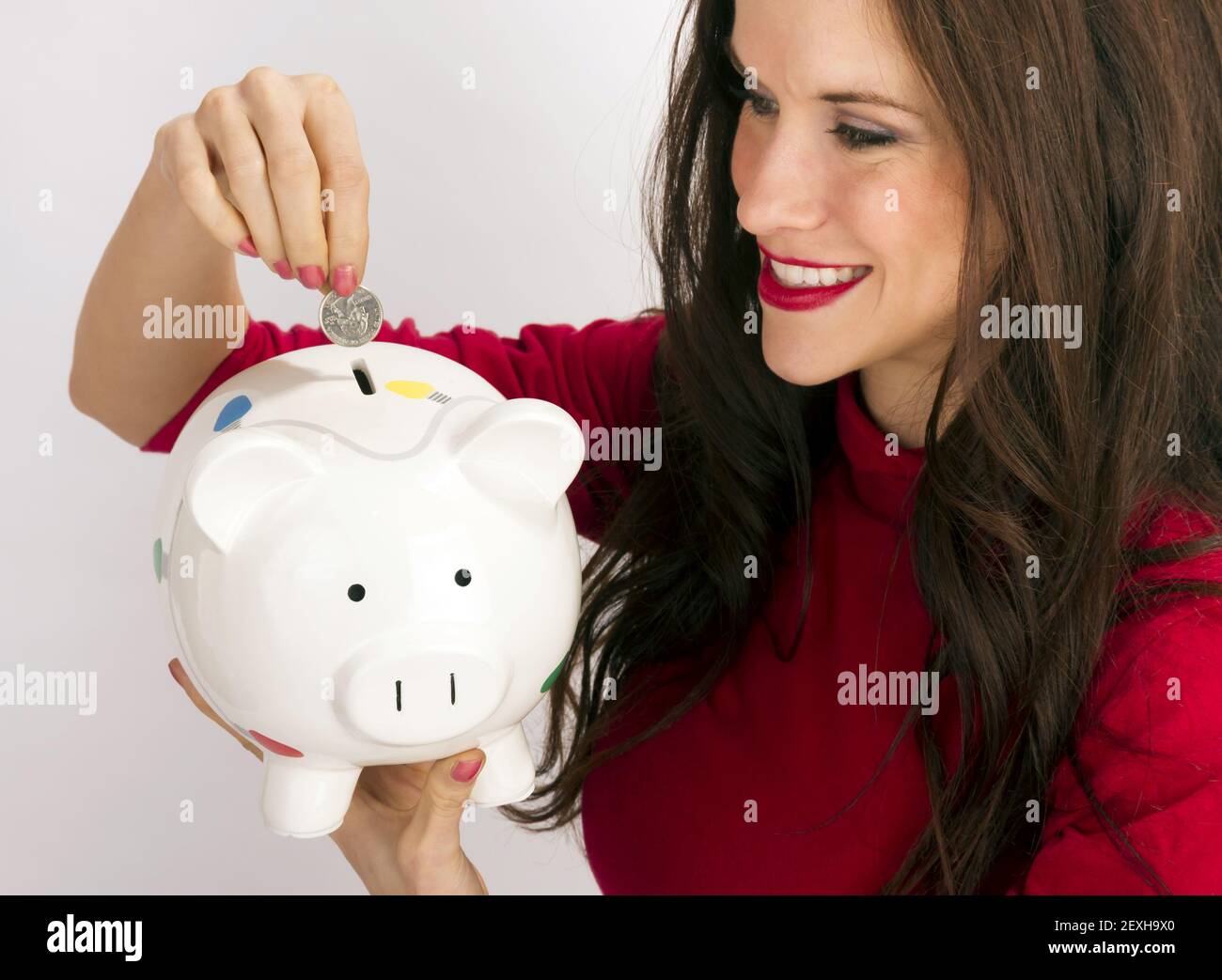 Pretty Happy Brunette Woman Drops Quarter Coin Savings Bank Stock Photo