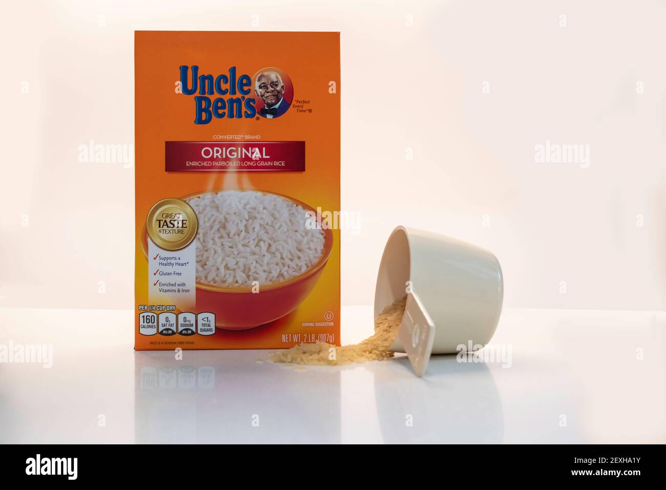 A box of Uncle Ben's rice isolated on white with spilled rice, a subject of objection due to racial injustice and prejudicial outrage because of t Stock Photo