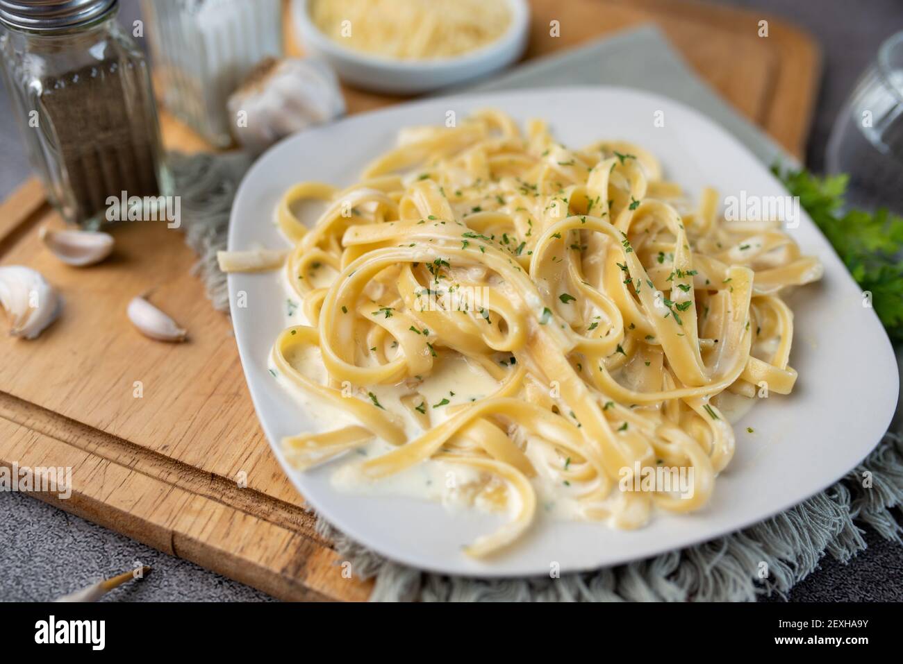 Alfredo pasta dinner with creamy white sauce and herbs Stock Photo Alamy