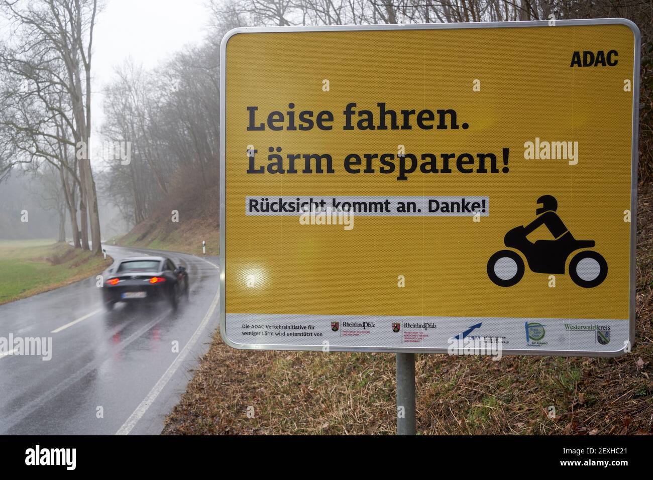 Montabaur, Germany. 04th Mar, 2021. A sign on the country road in the Gelbach valley asks motorcyclists to drive quietly and considerately. Before the start of the season, the ADAC is launching a pilot project against motorcycle noise - supported by the state of Rhineland-Palatinate. (to dpa: 'Pilot project and further measures against motorcycle noise for the start of the season'). Credit: Thomas Frey/dpa/Alamy Live News Stock Photo