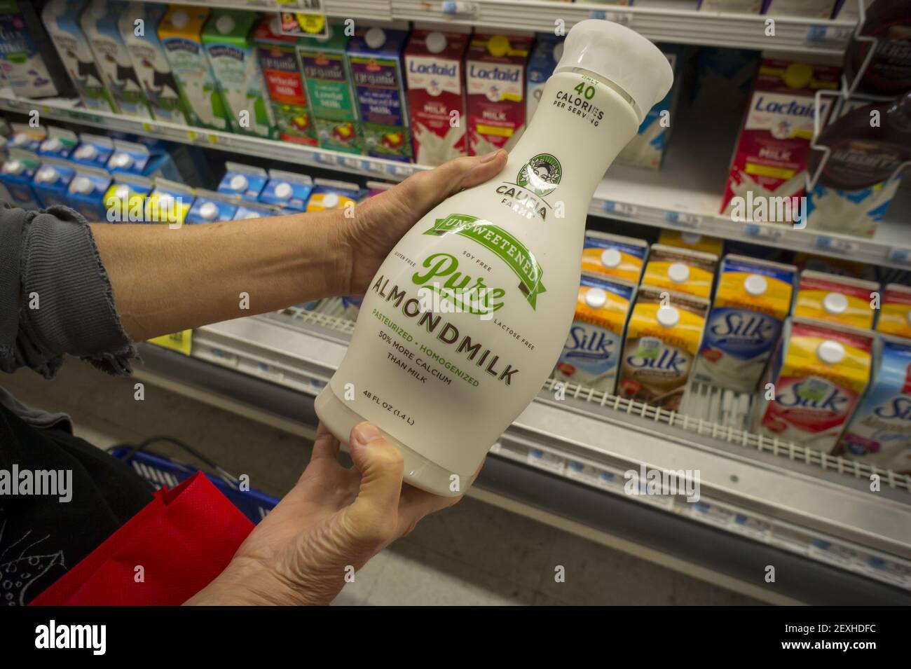 A customer chooses Califia brand almond milk in a supermarket in New