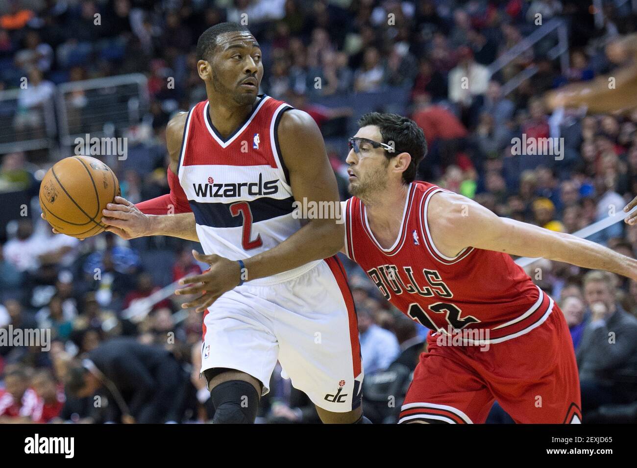 Chicago Bulls shooting guard Kirk Hinrich (12) tries to poke the ball away  from Washington Wizards point guard John Wall (2) during the second half of  their game played at the Verizon