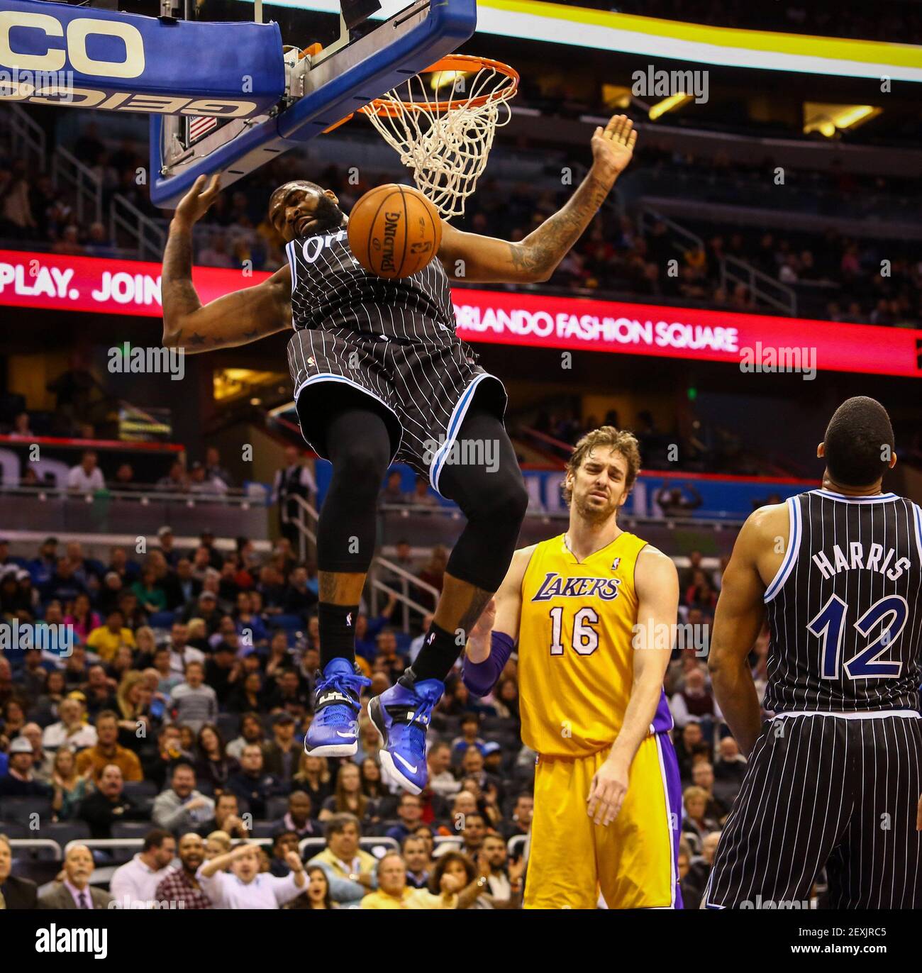 The Orlando Magic's Kyle O'Quinn dunks the ball off an assist from Tobias  Harris (12) against Pau Gasol (16) and the Los Angeles Lakers during  fourth-quarter action at Amway Center in Orlando,