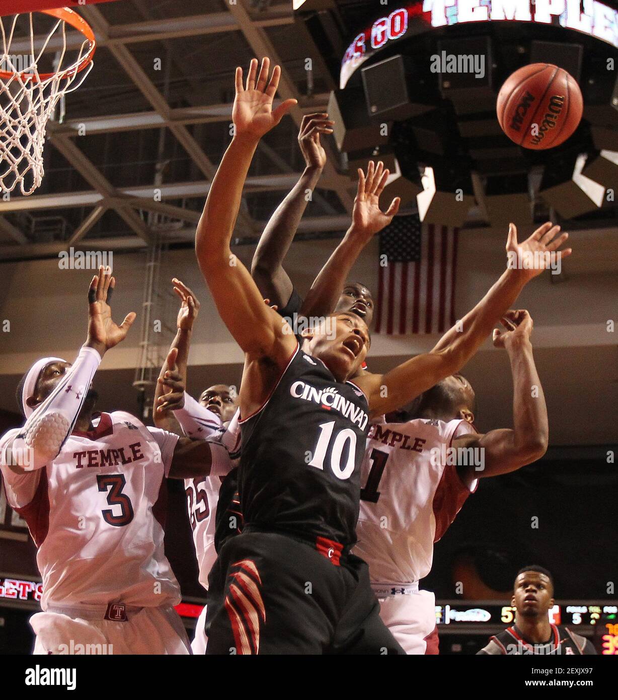 Temple's Anthony Lee, left, Quenton DeCosey, second from left, and Josh  Brown, right, battle Cincinnati's Troy Caupain, center, and Shaquille Thomas  for the rebound in the 2nd quarter. The Cincinnati Bearcats beats