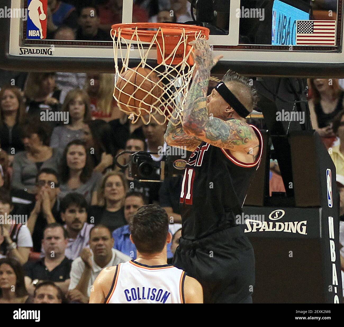 Miami Heat's Chris "Birdman" Andersen dunks over Oklahoma City Thunder's  Nick Collison during the first quarter at AmericanAirlines Arena in Miami  on Wednesday, Jan. 29, 2014. (Photo by Pedro Portal/El Nuevo Herald/MCT/Sipa