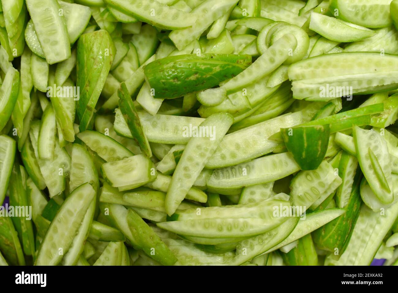 Coccinia grandis, ivy gourd known as scarlet gourd, Indian tindora, tindi, tendli and kowai fruit. Sliced, Diced and heap Stock Photo