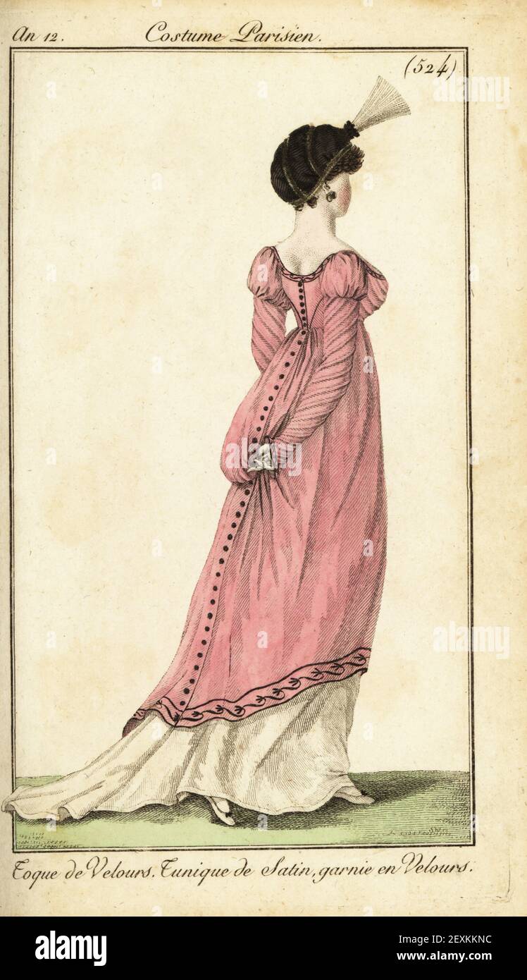 Woman in velvet toque hat with plume, satin tunic dress garnished in velvet. Toque de Velours, Tunique de Satin, garnie en Velours. Handcoloured copperplate engraving from Pierre de la Mesangere’s Journal des Dames et des Modes, Magazine of Women and Fashion, Paris, An 12, January 1804. Illustrations by Carle Vernet, Jean-Francois Bosio, Dominique Bosio and Philibert Louis Debucourt, engraved by Pierre-Charles Baquoy. Stock Photo
