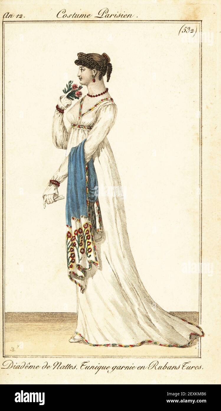 Woman in low-cut tunic dress decorated with Turkish ribbons. Her hairstyle is a braided diadem. Coral necklace, earrings and bracelets. She holds a fan, bouquet and shawl.  Diadem de nattes, tunique garnie en rubans Turcs. Handcoloured copperplate engraving by Pierre Charles Baquoy from Pierre de la Mesangere’s Journal des Dames et des Modes, Magazine of Women and Fashion, Paris, An 12, 1803. Illustrations by Carle Vernet, Jean-Francois Bosio, Dominique Bosio and Philibert Louis Debucourt. Stock Photo