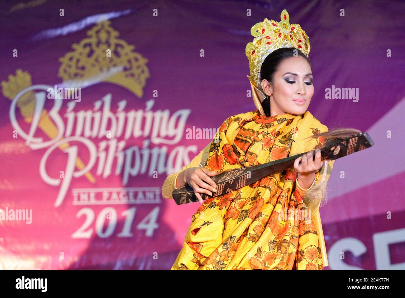 Quezon City, Philippines - A beauty pageant candidate performs a traditional Muslim dance while playing an instrument during the talent show portion of the Binibining Pilipinas 2014 held on Valentine's Day. The winners of the competition will represent the Philippines in different international beaty pageant contests. (Photo by Mark Cristino/Pacific Press/Sipa USA) Stock Photo