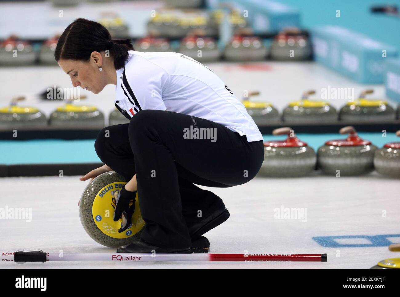 Switzerland's Carmen Kueng prepares a rock for a throw during women's curling semifinals at the Ice Cube Curling Center during the Winter Olympics in Sochi, Russia, Wednesday, Feb. 19, 2014. (Photo by Brian Cassella/Chicago Tribune/MCT/Sipa USA) Stock Photo
