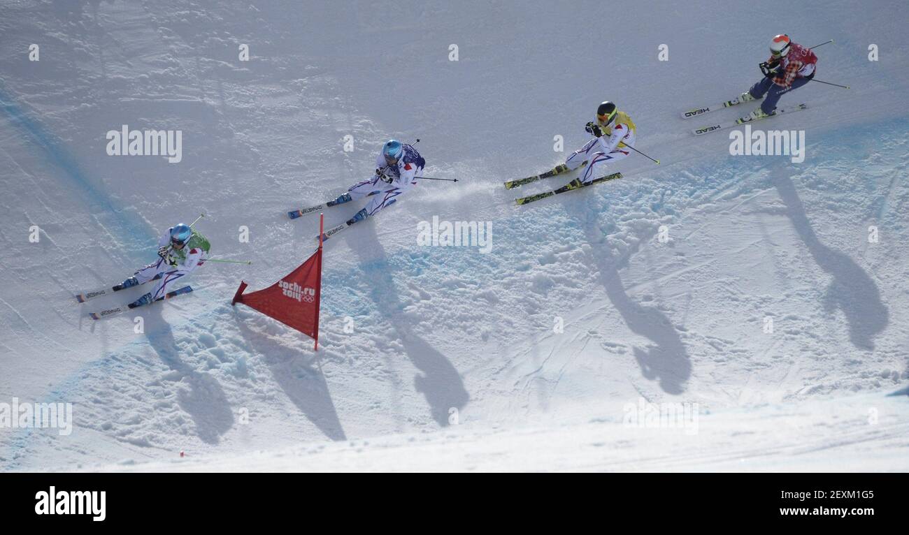 Jean Frederic Chapuis, left, of France, leads the pack on his way to a gold medal finish during the men's ski cross at the Winter Olympics in Sochi, Russia, on Thursday, Feb. 20, 2014. (Photo by Mark Reis/Colorado Springs Gazette/MCT/Sipa USA) Stock Photo