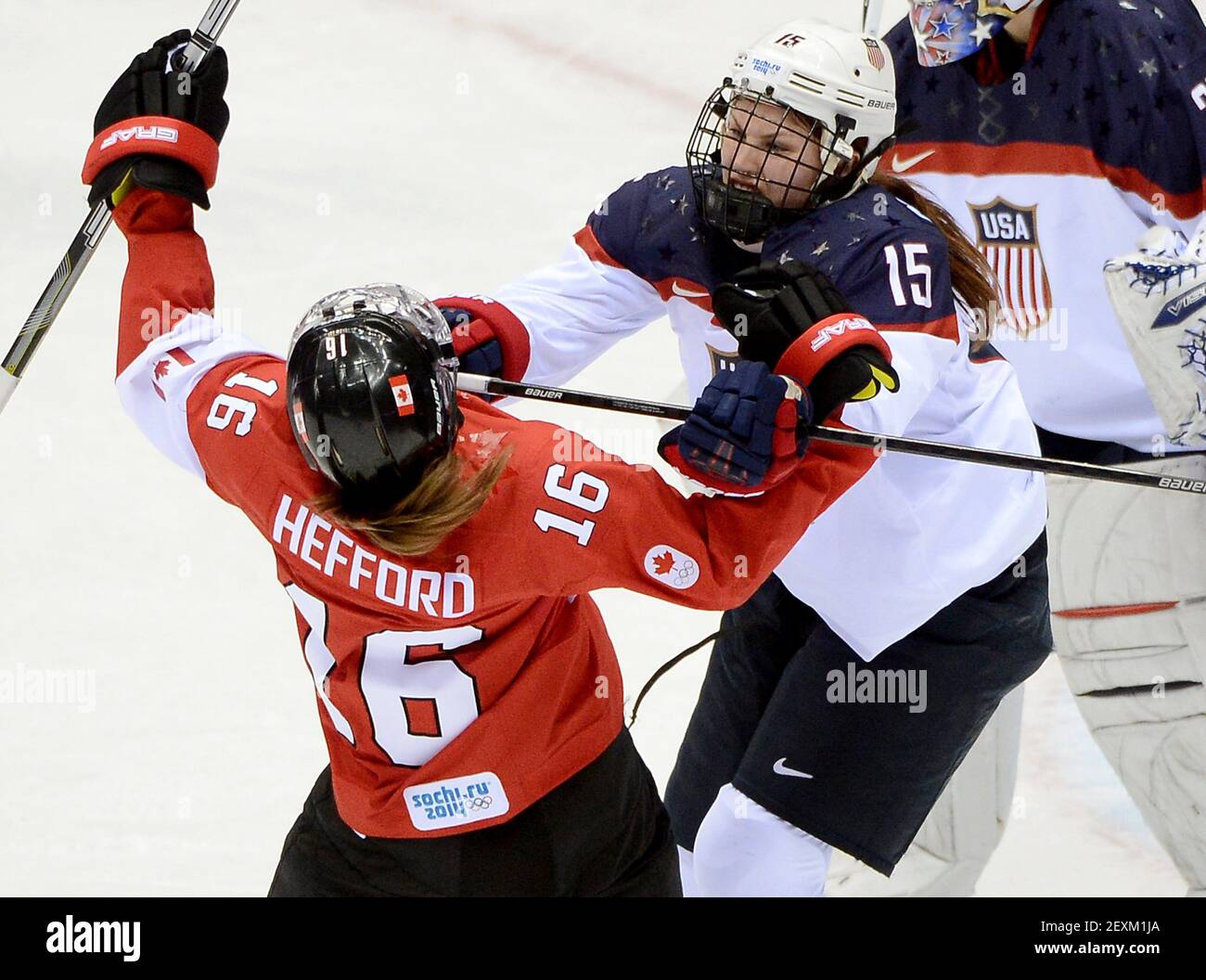 USA defenseman Anne Schleper (15) cross checks Canada forward Jayna Hefford  (16) in the second period of the women's hockey gold medal game at the  Bolshoy Ice Dome during the Winter Olympics