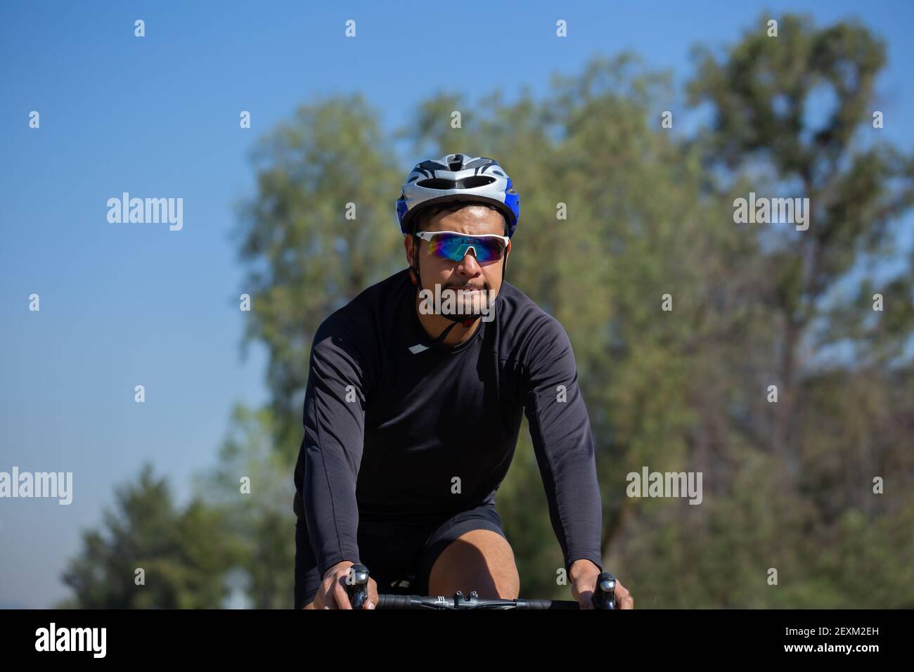 Hispanic Man Riding Bike Sports suit hi-res stock photography and images - Alamy