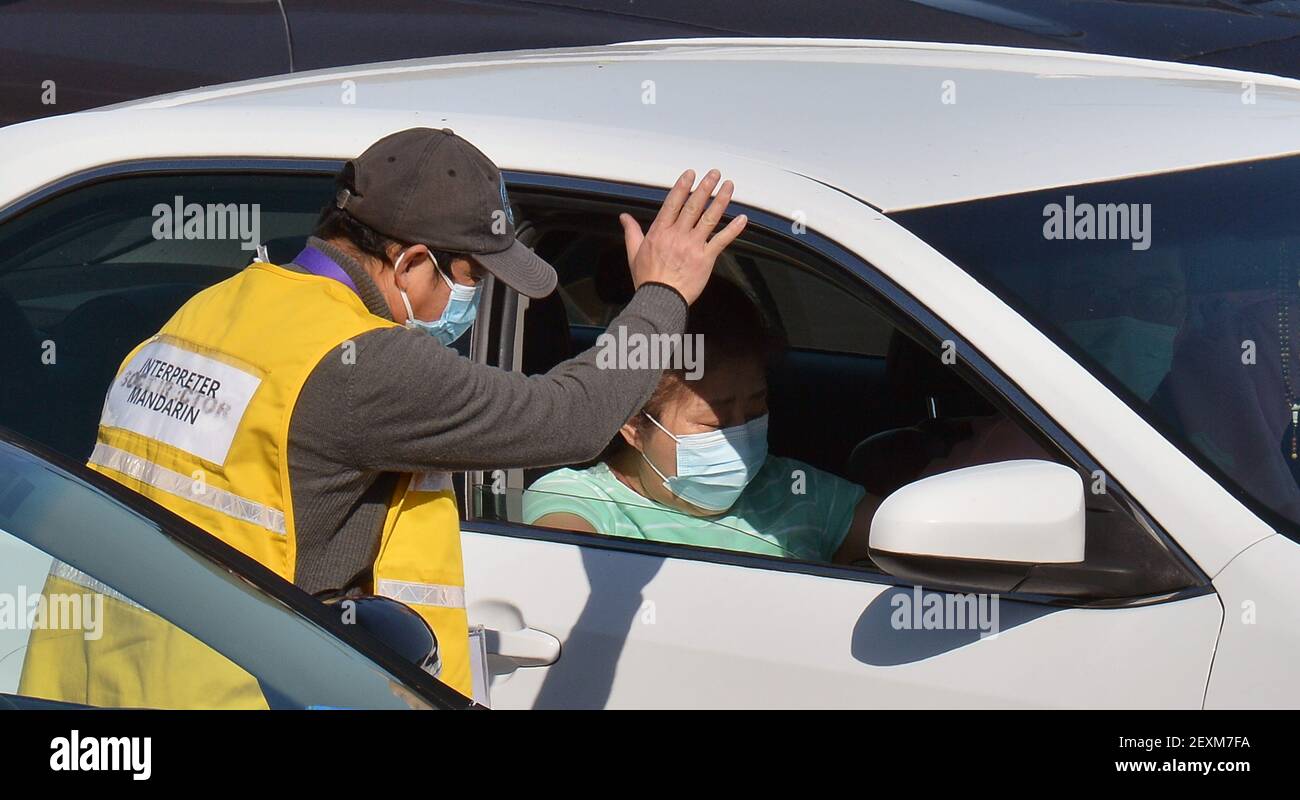 A Mandarin interpreter waves after assisting military personnel in administering COVID-19 shots to local residents at a FEMA drive-through vaccination site on the Cal State LA campus in Los Angeles on Thursday, March 4, 2021. California will begin sending 40% of all vaccine doses to the most vulnerable neighborhoods in the state to try to inoculate people most at risk from the coronavirus and get the state's economy open more quickly, Gov. Gavin Newsom said Thursday in the latest shake-up to the state's rules. Photo by Jim Ruymen/UPI Stock Photo